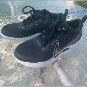 Nike tennis shoes. Black and rose gold detail.